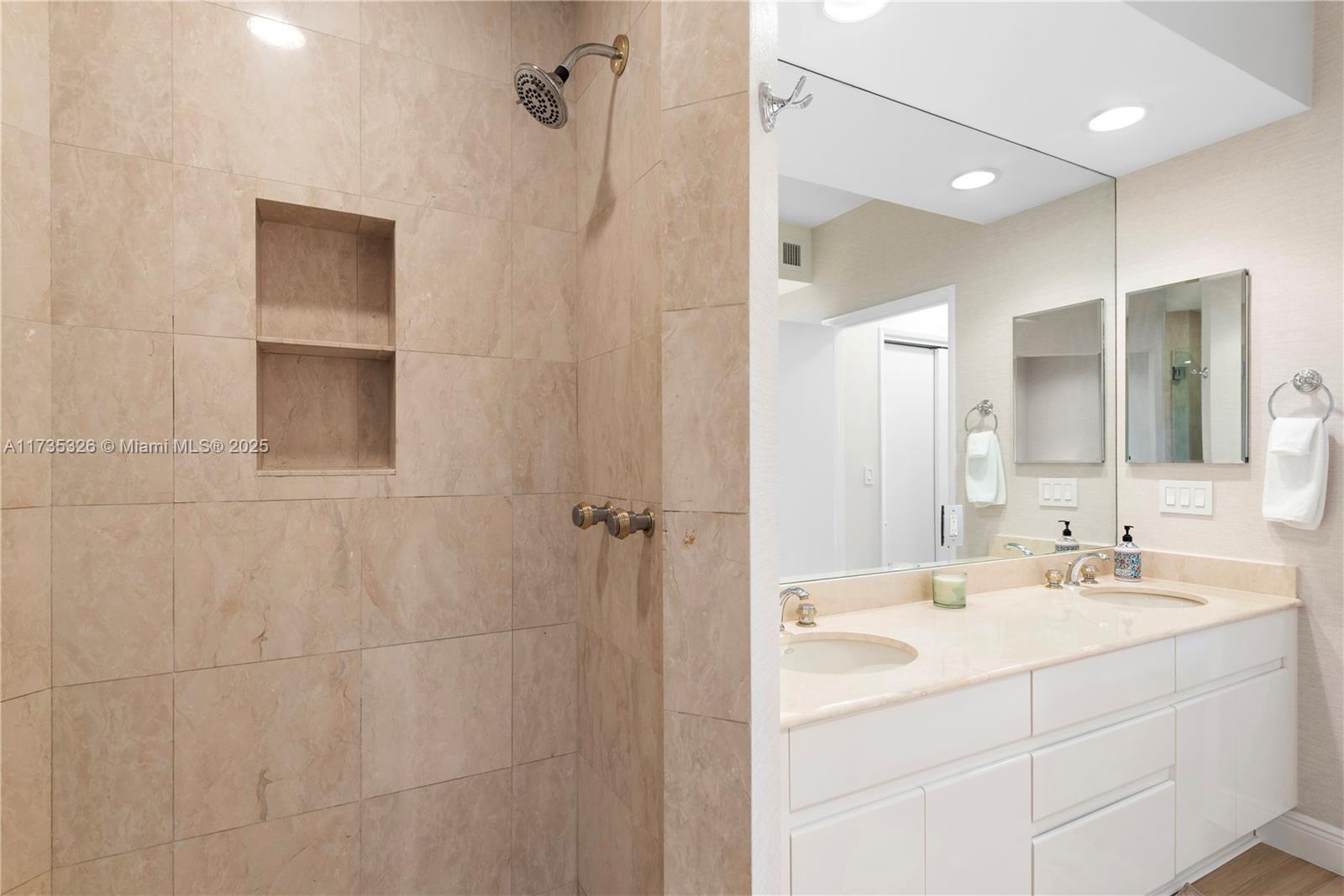 705 Crandon Boulevard, Unit 405 Key Biscayne, FL 33149 - Photo 21 of 29 a bathroom with a sink a vanity and a mirror