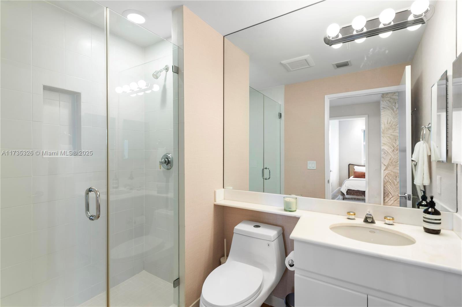 705 Crandon Boulevard, Unit 405 Key Biscayne, FL 33149 - Photo 22 of 29 a bathroom with a toilet sink shower and mirror