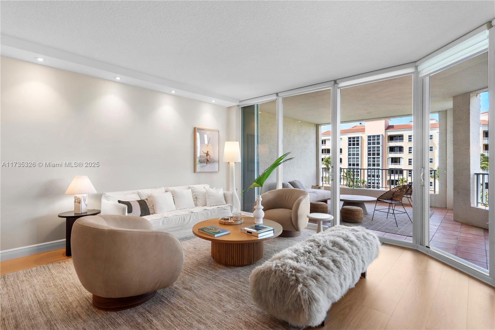705 Crandon Boulevard, Unit 405 Key Biscayne, FL 33149 - Photo 9 of 29 a living room with furniture and a large window