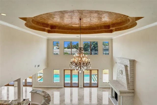 an empty room with floor to ceiling window and an outdoor view