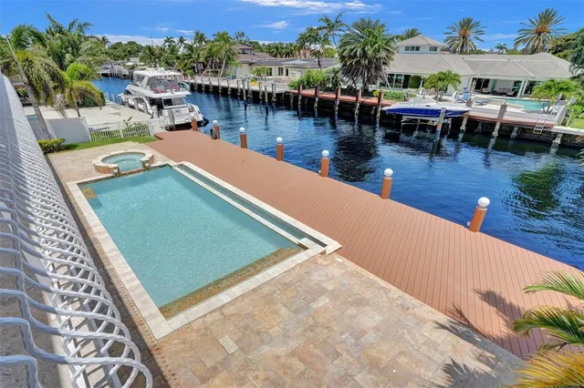 a large kitchen with stainless steel appliances kitchen island granite countertop a refrigerator and a sink