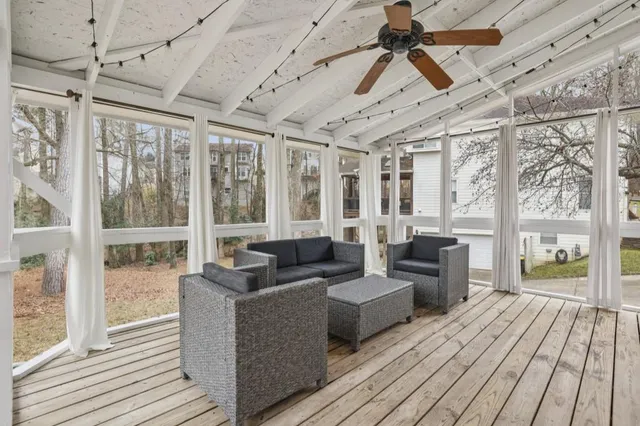 a living room with furniture and a floor to ceiling window