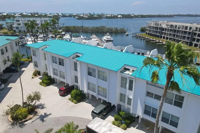 a view of a lake with a building and outdoor seating