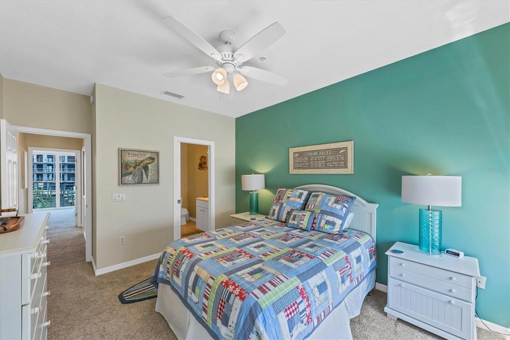 8272 Harborside Circle Englewood, FL 34224 - Photo 14 of 50 a bedroom with a bed and a lamp on table