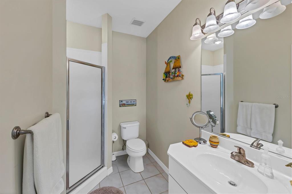 8272 Harborside Circle Englewood, FL 34224 - Photo 15 of 50 a bathroom with a sink a toilet and a mirror