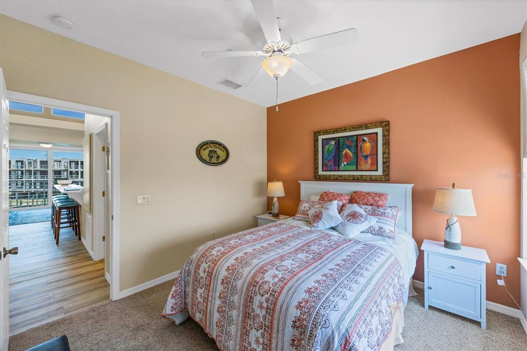 8272 Harborside Circle Englewood, FL 34224 - Photo 16 of 45 a bedroom with a bed and a chandelier