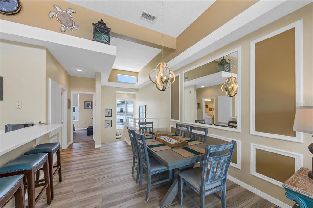 8272 Harborside Circle Englewood, FL 34224 - Photo 18 of 50 a view of a dining room with furniture and wooden floor