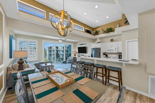 a room with stainless steel appliances kitchen island granite countertop furniture and a view of kitchen