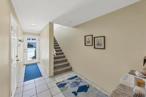 a view of a hallway with entryway wooden floor and front door