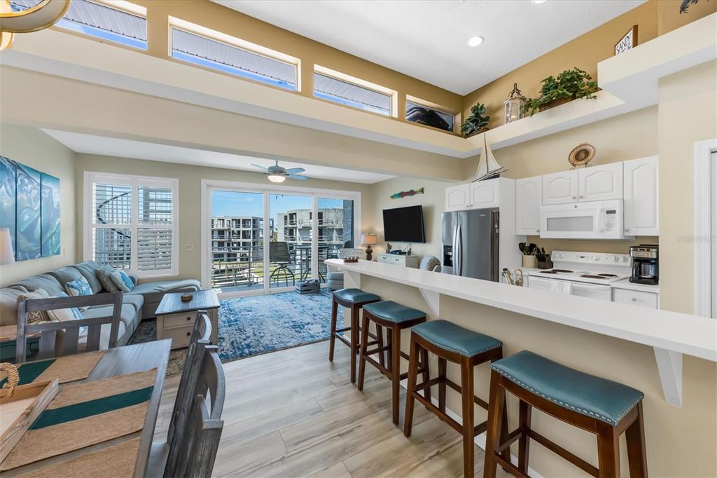 8272 Harborside Circle Englewood, FL 34224 - Photo 21 of 50 a room with stainless steel appliances kitchen island granite countertop furniture and a view of kitchen