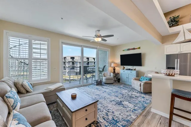 a living room with furniture and a floor to ceiling window