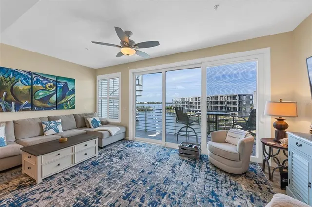 a living room with furniture and a floor to ceiling window