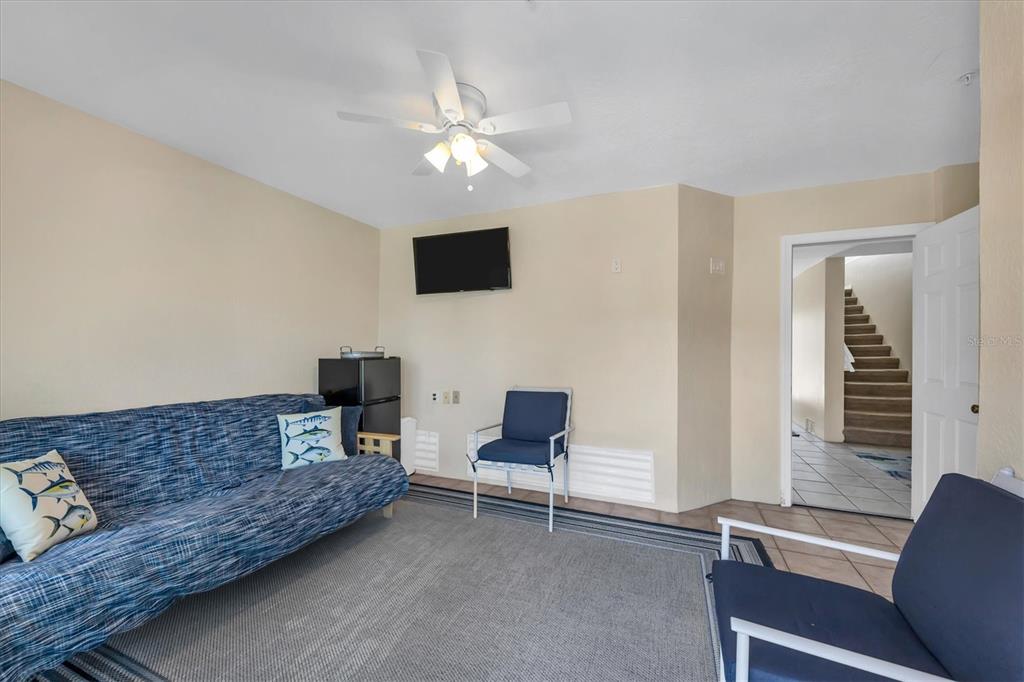 8272 Harborside Circle Englewood, FL 34224 - Photo 36 of 50 a living room with furniture and a flat screen tv