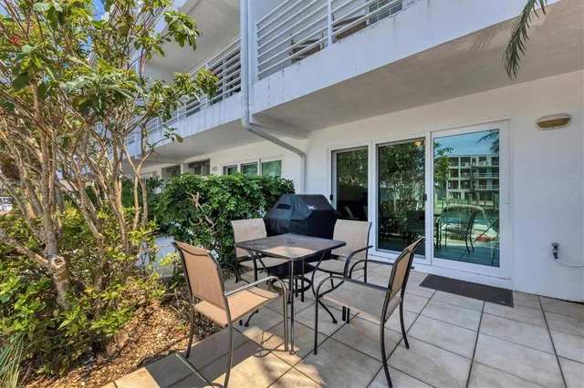 a view of backyard with outdoor seating and plants