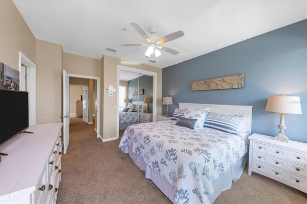 a bedroom with bed and a chandelier