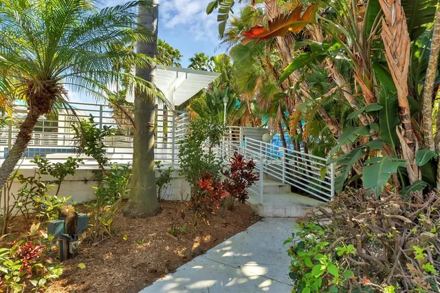 a view of house with backyard and a slide