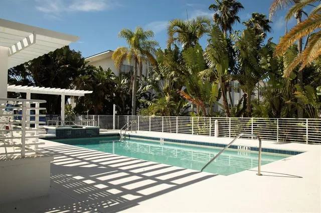 a swimming pool with outdoor seating and yard