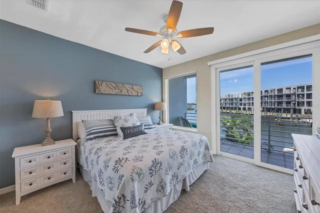 a bedroom with bed and a chandelier