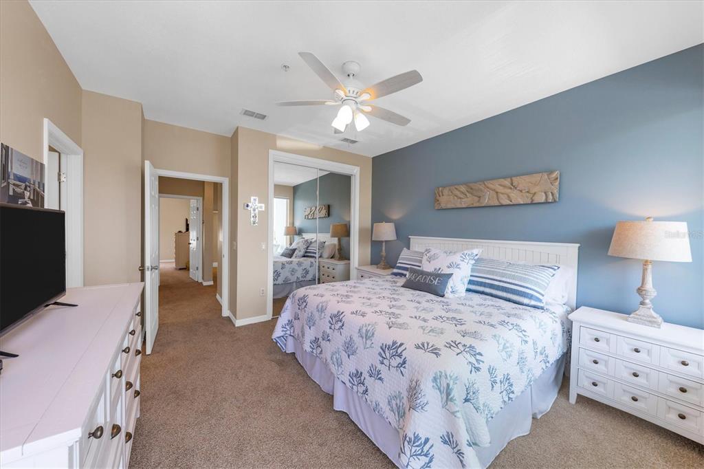 8272 Harborside Circle Englewood, FL 34224 - Photo 9 of 50 a bedroom with bed and a chandelier