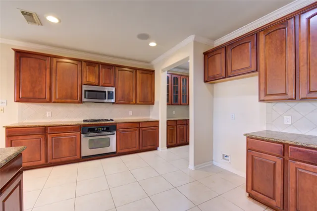 a view of a kitchen with a sink and chandelier