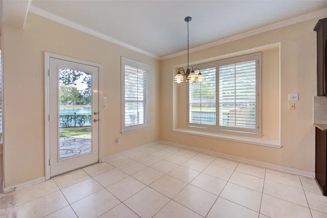a view of a big room with chandelier fan and windows