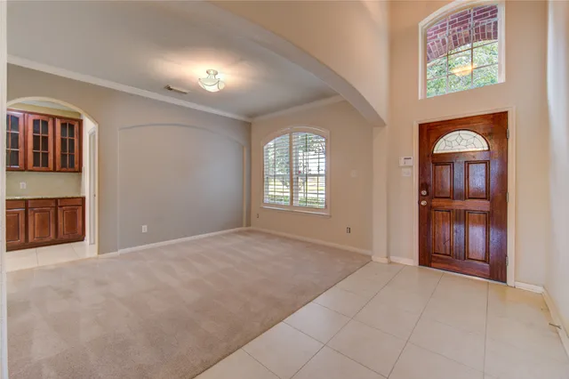 an empty room with windows and closet