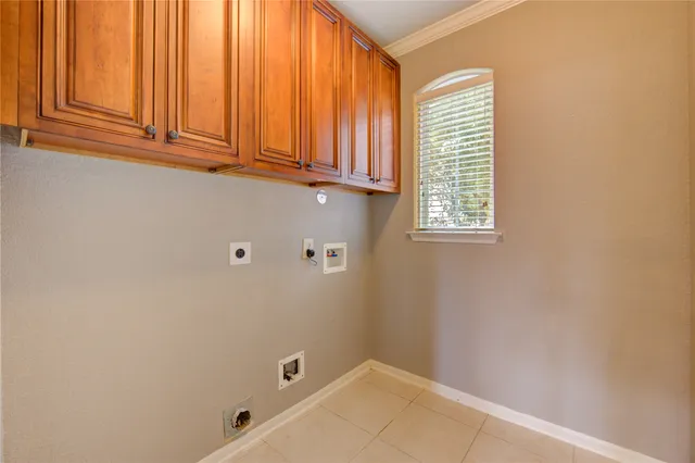 a kitchen with stainless steel appliances granite countertop a stove top oven a sink dishwasher and a refrigerator with wooden cabinets