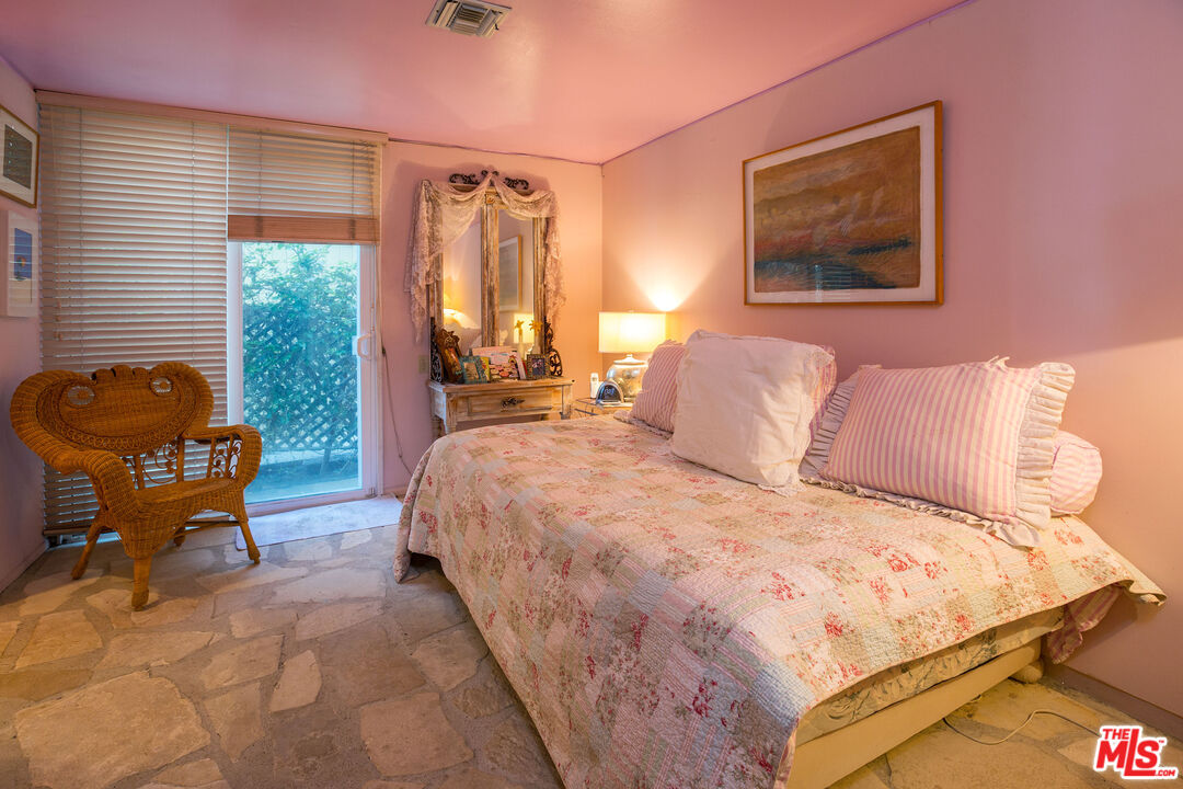 24102 Malibu Road Malibu, CA 90265 - Photo 11 of 14 a bedroom with a bed and a window