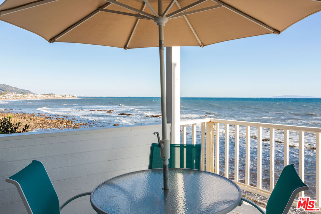 24102 Malibu Road Malibu, CA 90265 - Photo 3 of 14 a view of a balcony with chair and an umbrella