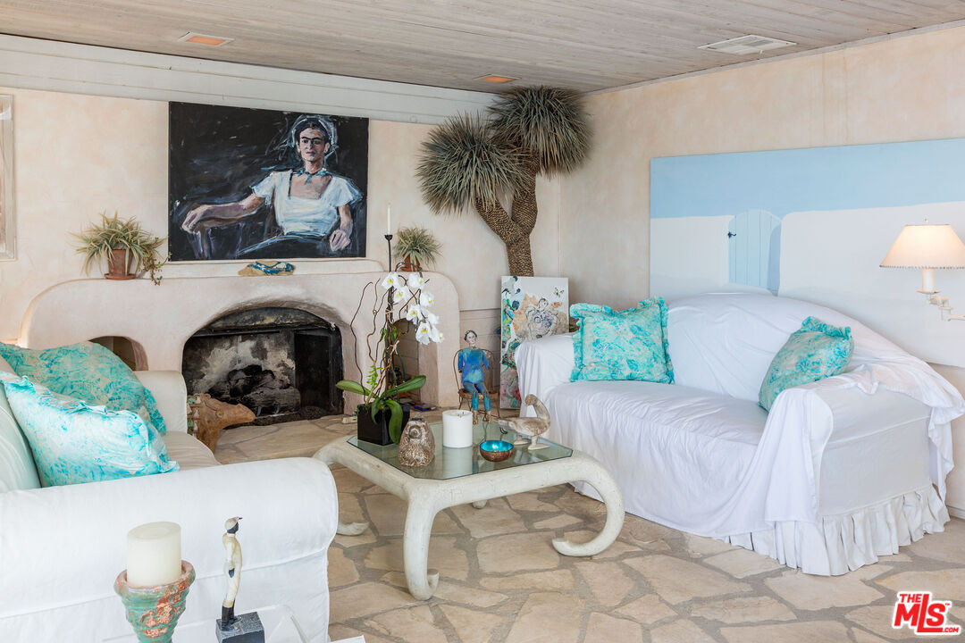 24102 Malibu Road Malibu, CA 90265 - Photo 6 of 14 a living room with furniture and a fireplace