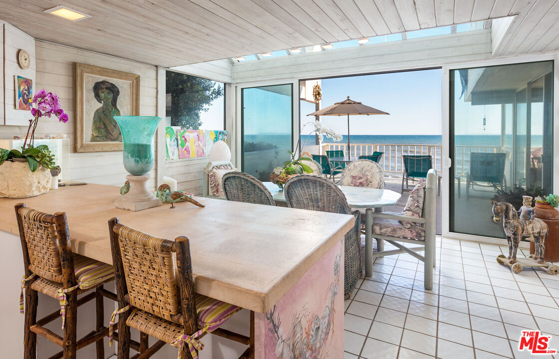 24102 Malibu Road Malibu, CA 90265 - Photo 7 of 14 a view of a dining room with furniture and a potted plant