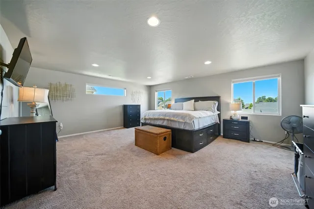 a spacious bedroom with a bed and furniture