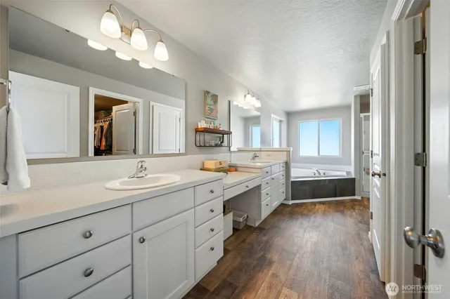 a large bathroom with double vanity and a mirror