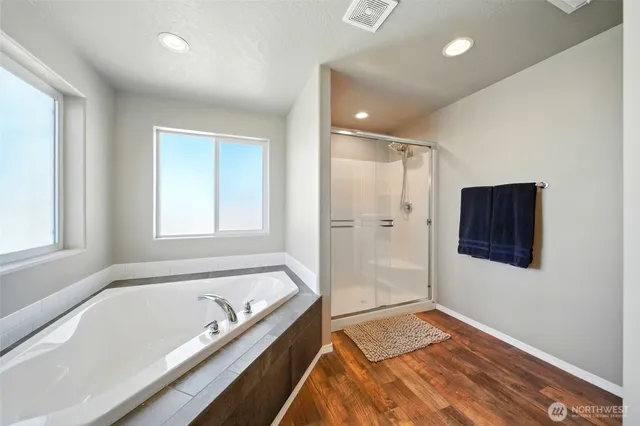 a bathroom with a bathtub and a shower