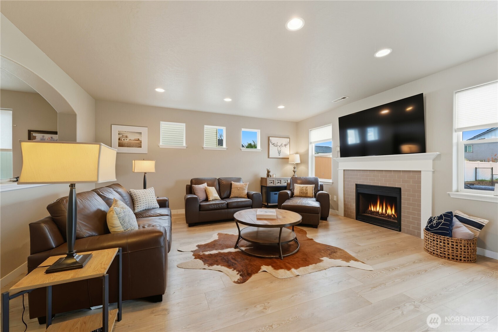 1382 Caprio Loop Walla Walla, WA 99362 - Photo 3 of 36 a living room with furniture a fireplace and a flat screen tv