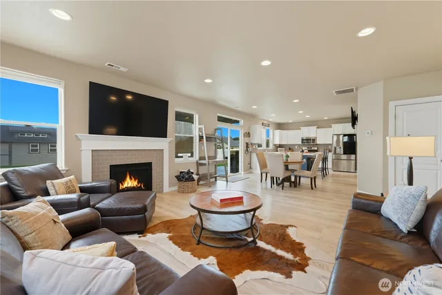 a living room with furniture a fireplace and a flat screen tv