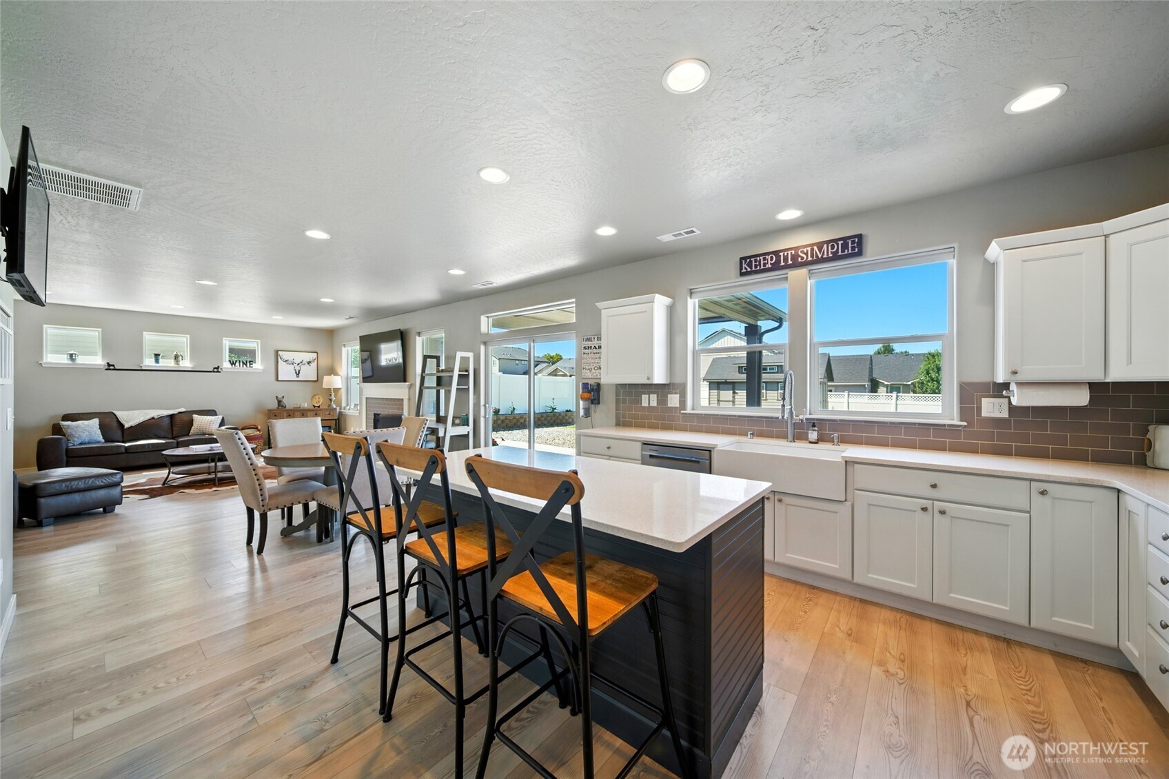 1382 Caprio Loop Walla Walla, WA 99362 - Photo 6 of 36 a kitchen with stainless steel appliances granite countertop a dining table chairs and wooden floor