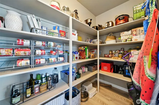 a room with storage and a white refrigerator