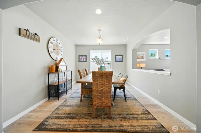 a dining room with furniture a rug and a window