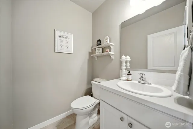 a bathroom with a sink toilet and a mirror