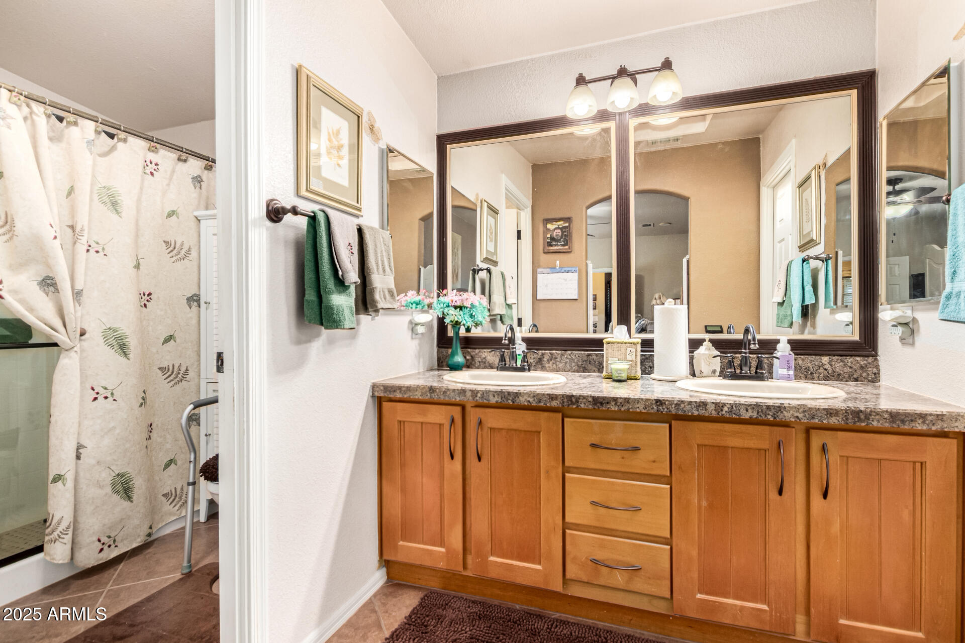 3301 South Goldfield Road, Unit 2090 Apache Junction, AZ 85119 - Photo 14 of 35 a bathroom with a granite countertop sink a mirror a vanity and a shower