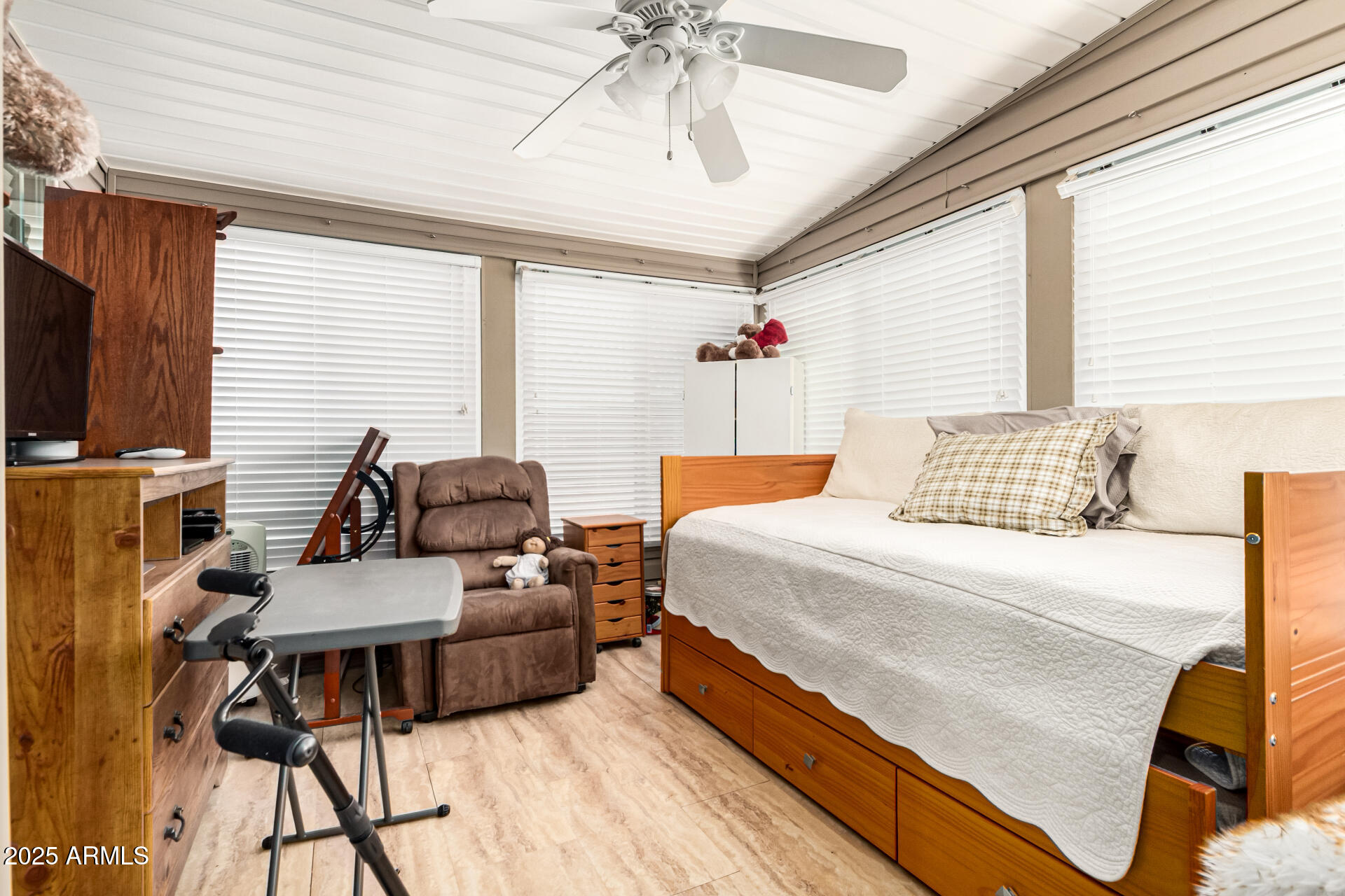 3301 South Goldfield Road, Unit 2090 Apache Junction, AZ 85119 - Photo 16 of 35 a bedroom with a bed and a chandelier