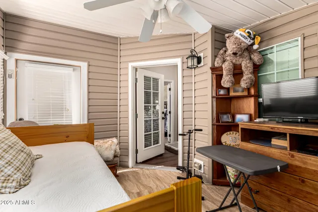 a bedroom with a bed and a flat screen tv