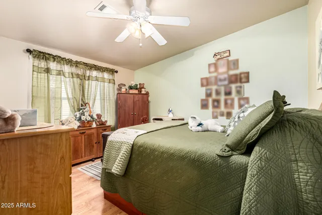 a bed sitting in a bedroom next to a window