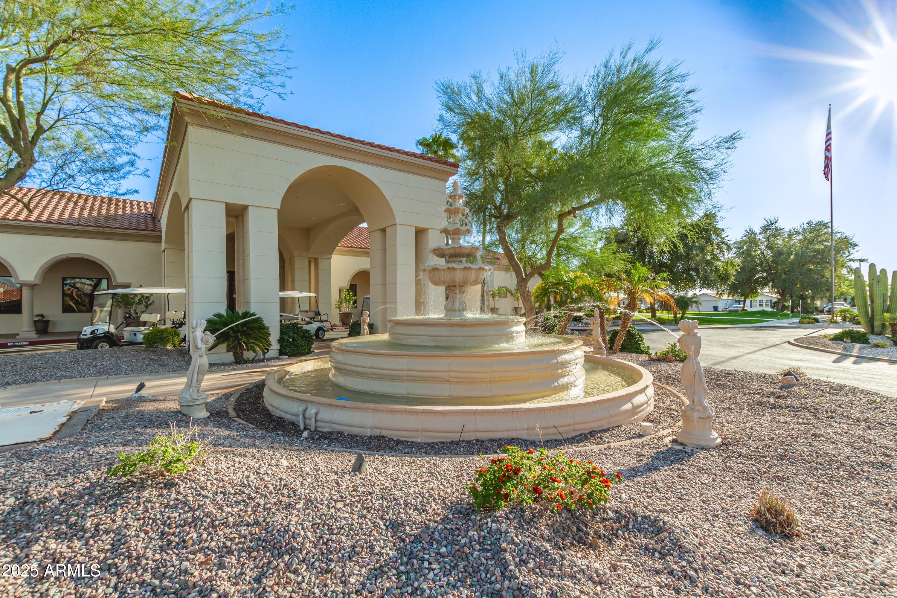 3301 South Goldfield Road, Unit 2090 Apache Junction, AZ 85119 - Photo 22 of 35 a front view of a house with garden