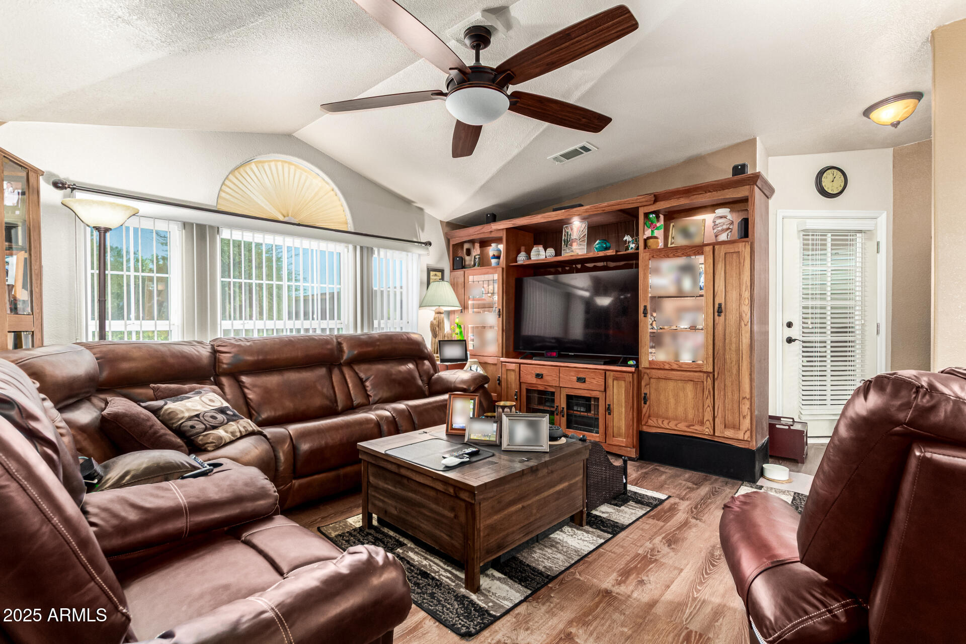 3301 South Goldfield Road, Unit 2090 Apache Junction, AZ 85119 - Photo 3 of 35 a living room with furniture a flat screen tv and a window