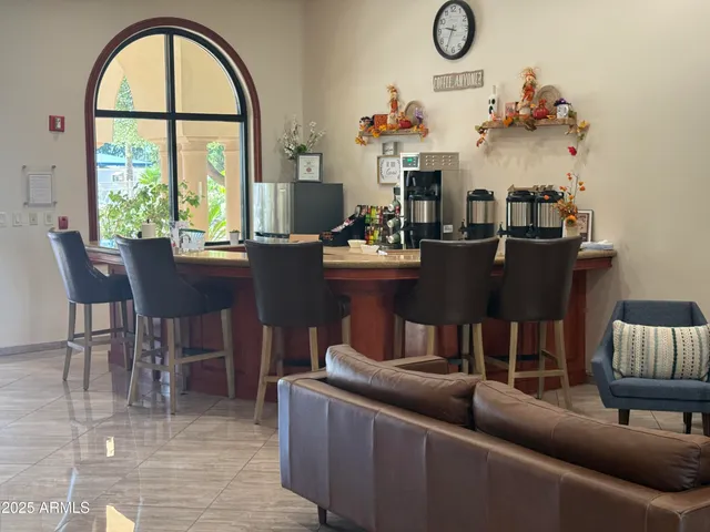 a living room with fireplace furniture and a large window