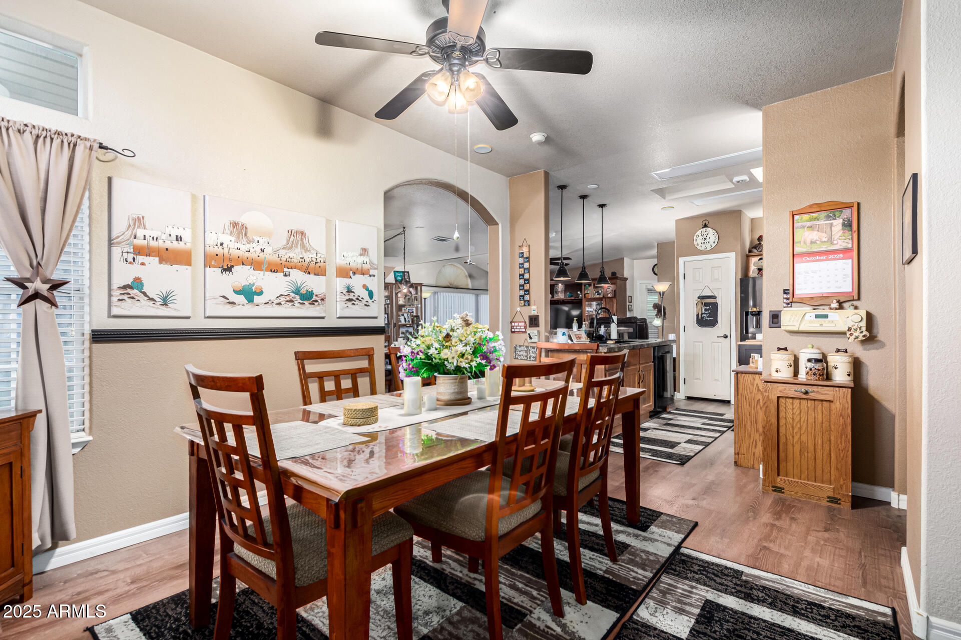 3301 South Goldfield Road, Unit 2090 Apache Junction, AZ 85119 - Photo 4 of 35 a view of a dining room with furniture and a chandelier fan