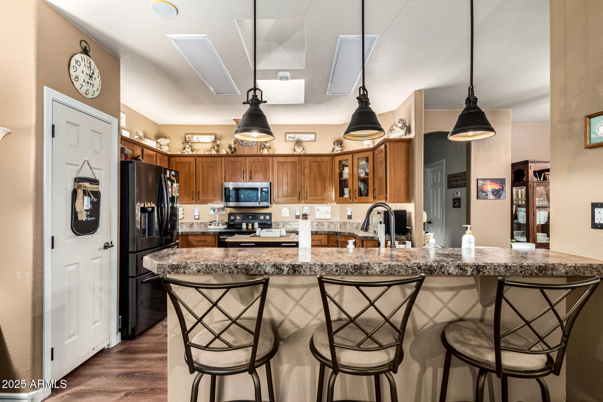 3301 South Goldfield Road, Unit 2090 Apache Junction, AZ 85119 - Photo 8 of 35 a dining table with chairs and kitchen view
