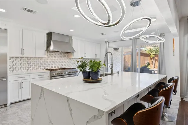 a kitchen with a table a sink and cabinets